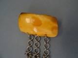 Brooch, amber with three chains 12.5gr.