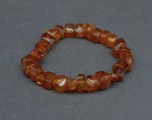 Amber bracelet on rubber. Amber tablets, cognac color