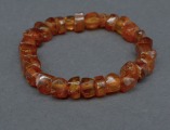 Amber bracelet on rubber. Amber tablets, cognac color