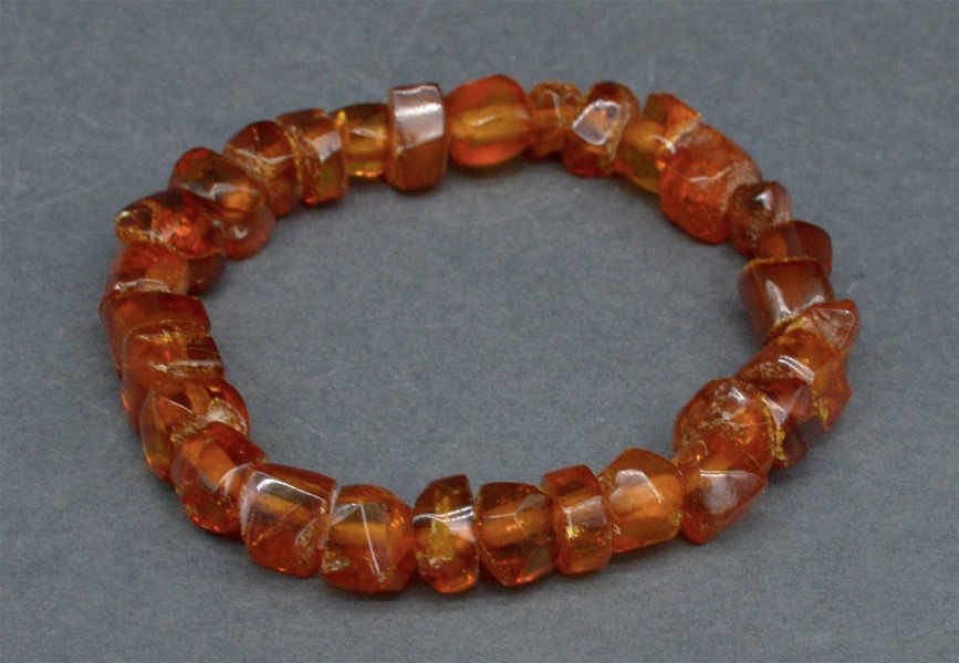 Amber bracelet on rubber. Amber tablets, cognac color
