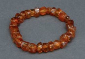 Amber bracelet on rubber. Amber tablets, cognac color