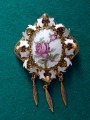 Ceramic brooch with rose and pendants