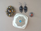 Powder box, brooch, sakta and earrings